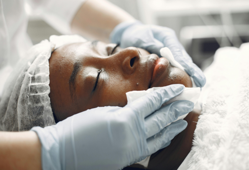 A woman is getting her face waxed