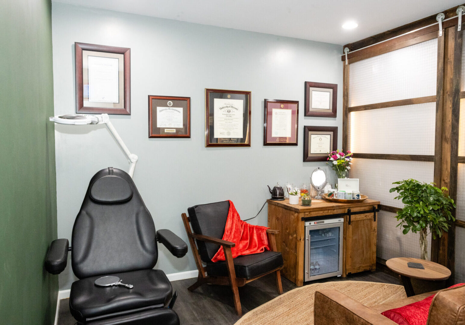 A room with several framed certificates on the wall.